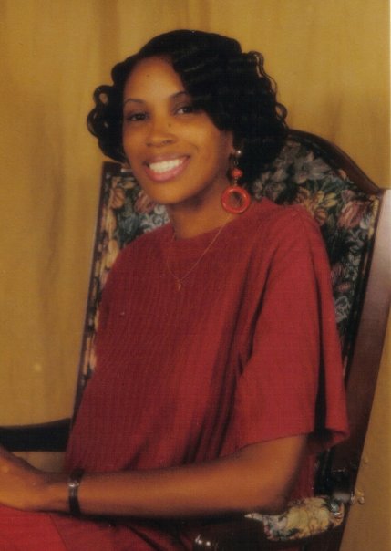 A quite beautiful woman sitting in a chair